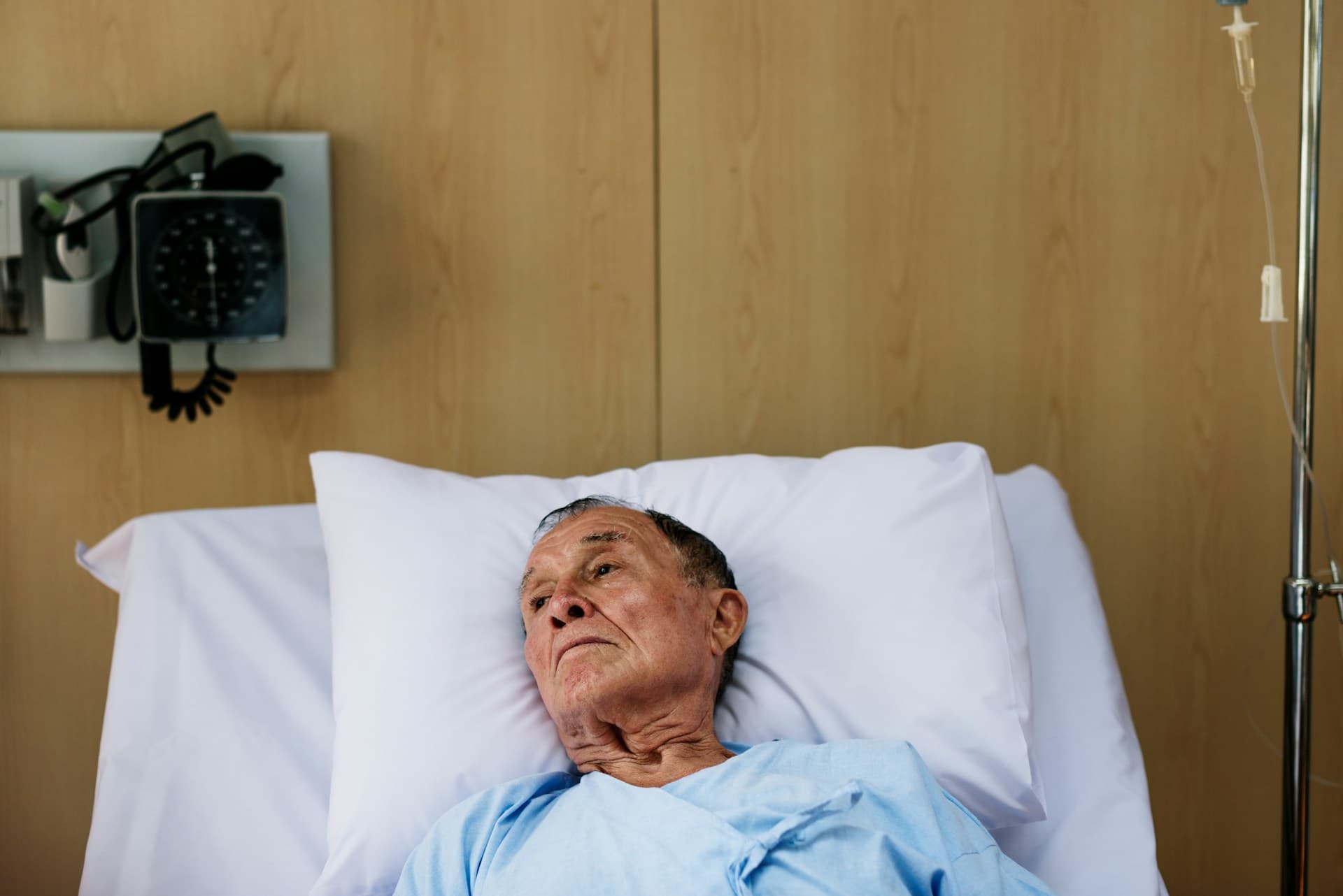a man lying in a hospital bed