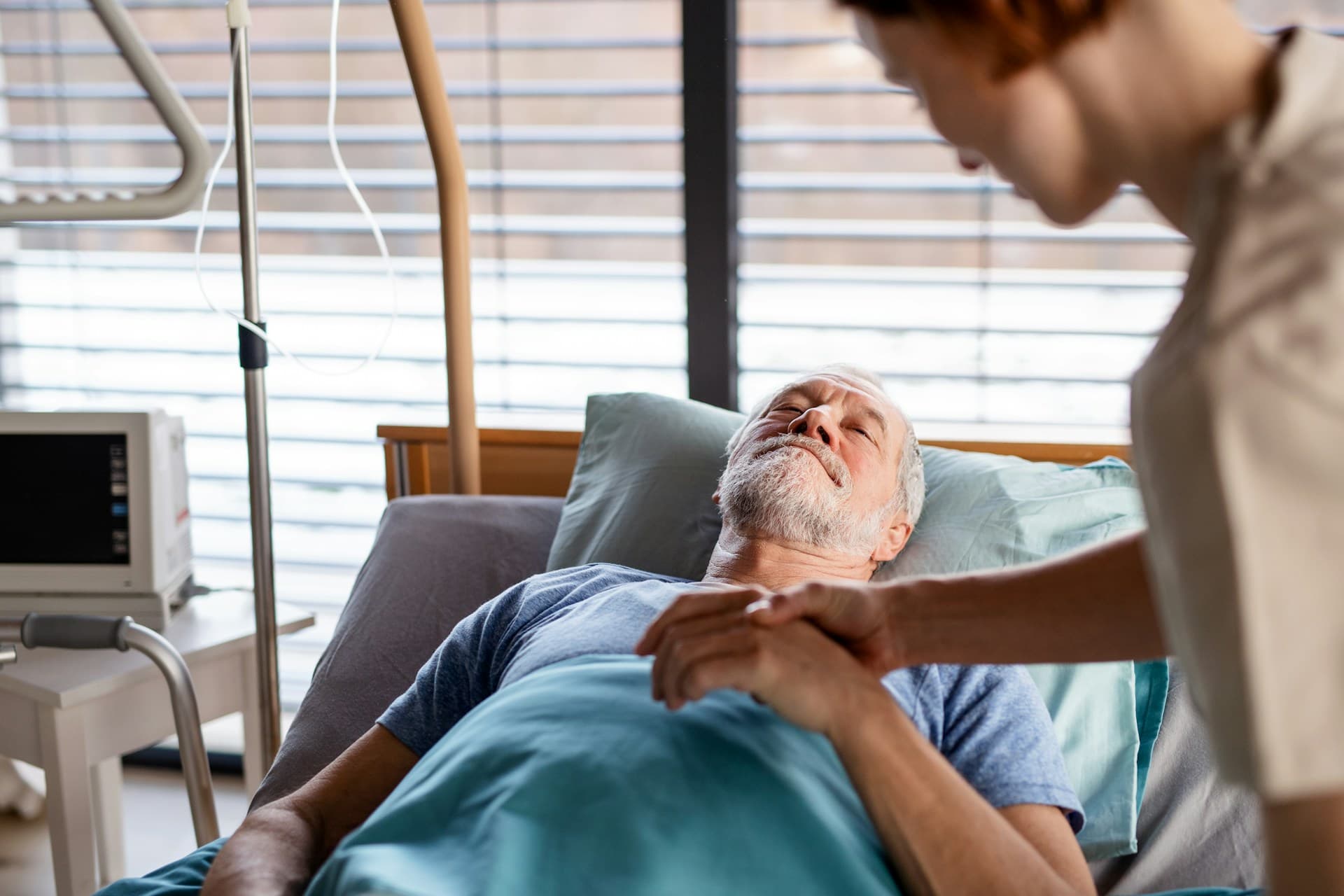 a man lying in a hospital bed