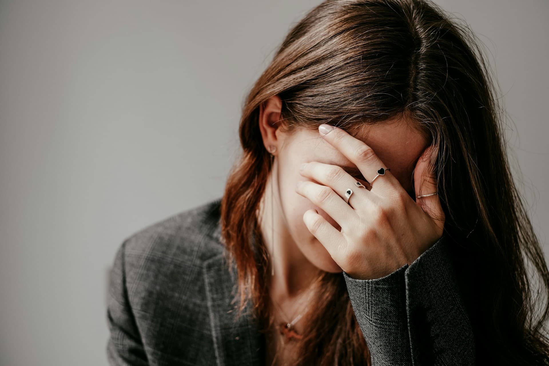 a woman covering her face with her hand